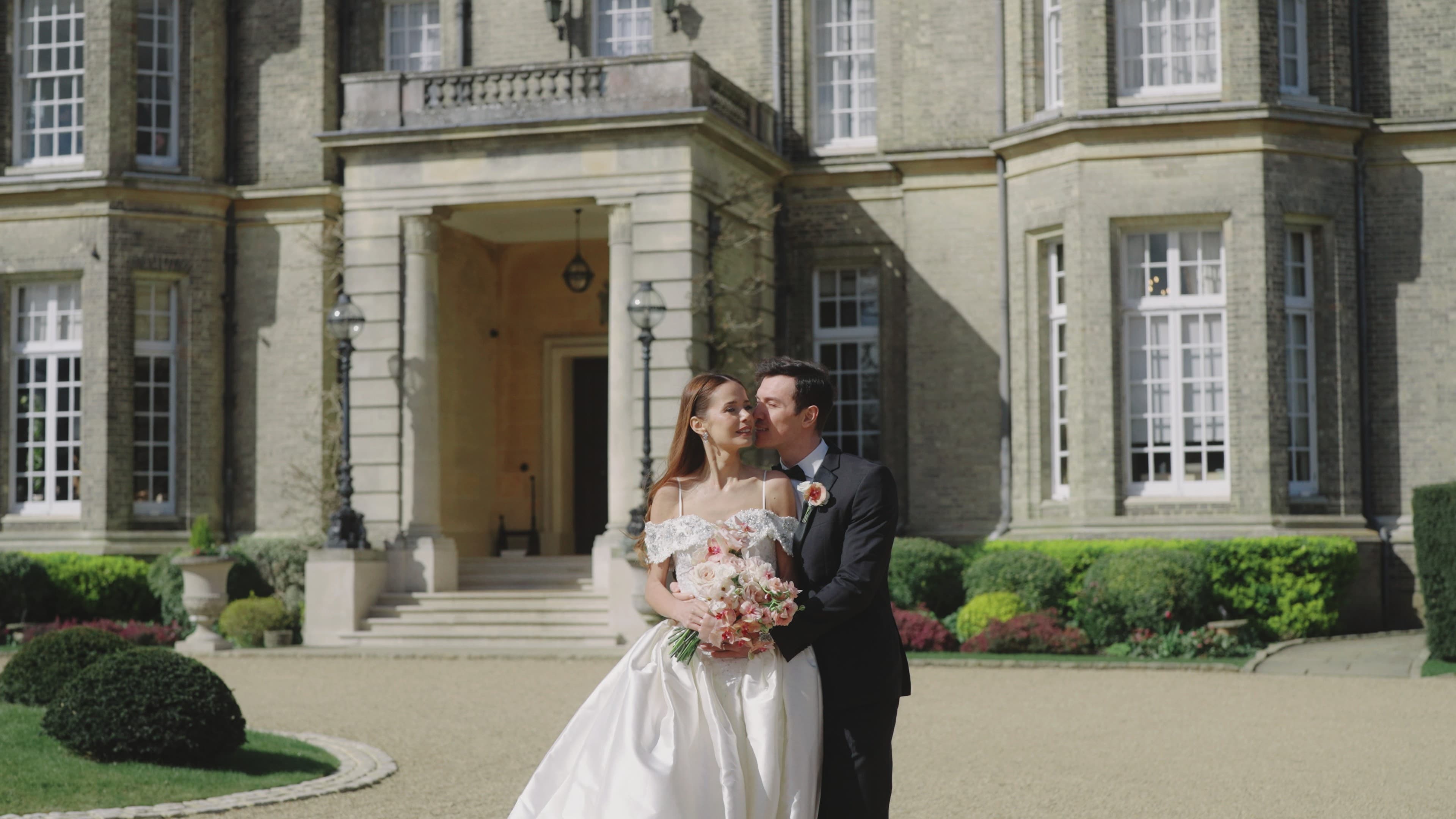 Bride and groom outside a historic manor
